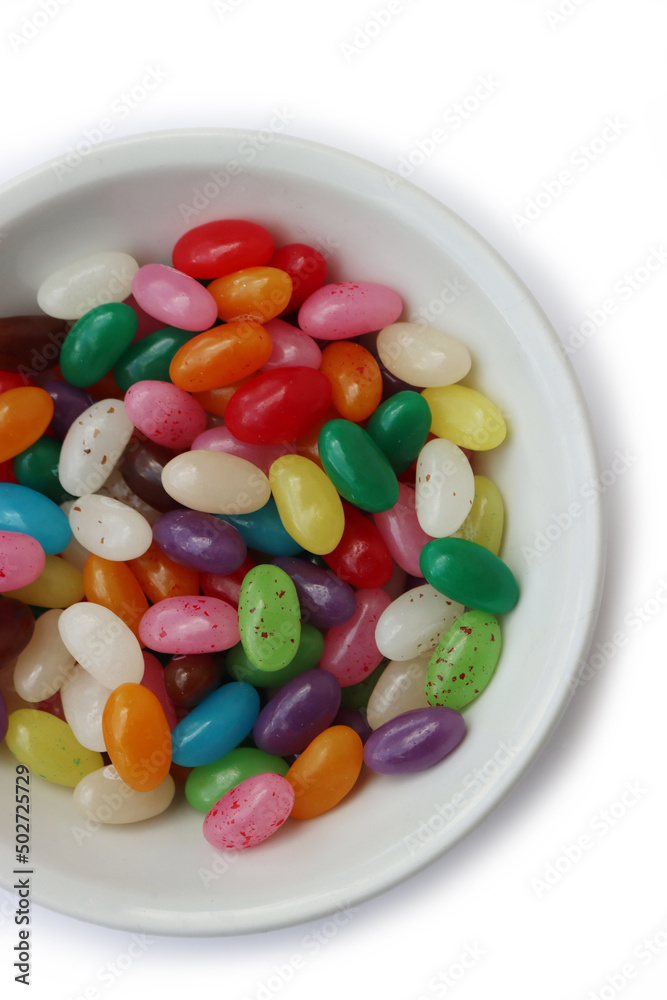 Colorful candies in a white ceramic bowl isolated on white backgrounds Colorful candies in a white ceramic bowl isolated on white backgrounds