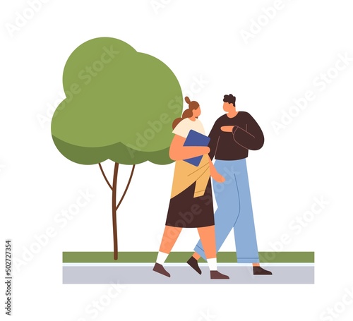 Love couple of students walking in street, talking. Man and woman friends goi...