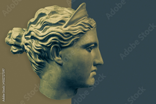 Plaster sculpture of woman face. Bronze color gypsum copy of ancient statue of Diana head for artists. Diana in Roman mythology the goddess of nature and hunting. Renaissance epoch sample. Template.