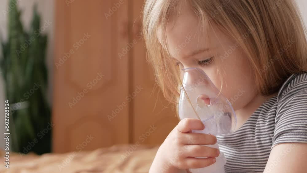 little girl threeyearold uses nebulizer, inhaler, breathes medicine