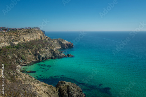 Top view of the Black Sea coast near steep mountains with turquoise water