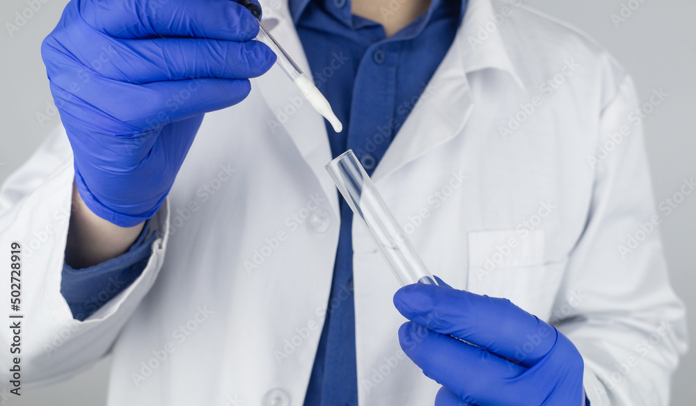 Medical laboratory assistant checks a test tube with sperm. Spermogram. Male fertility test. Semen in a test tube. Reproductive system check. Donor suitability test for artificial insemination Medical laboratory assistant checks a test tube with sperm. Spermogram. Male fertility test. Semen in a test tube. Reproductive system check. Donor suitability test for artificial insemination
