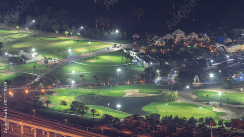 Aerial view to Golf course with green lawn and lakes night timelapse.