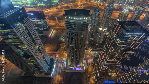 Look down aerial view of a road intersections between skyscrapers in a big city timelapse.