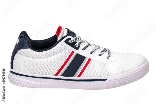 White sneakers isolated. Close-up of a single white elegant stylish leather sport shoe isolated on a white background. Clipping path. Kids shoe fashion. Modern design footwear for workout. Macro.