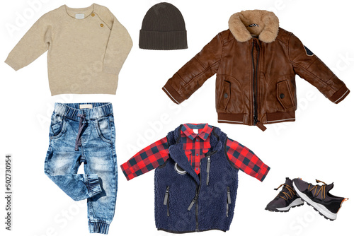 Collage set of little boys spring clothes isolated on a white background. A trendy stylish brown leather jacket, denim trousers or pants, sneaker, vest with shirt and pullover or sweater and hood for © Olga