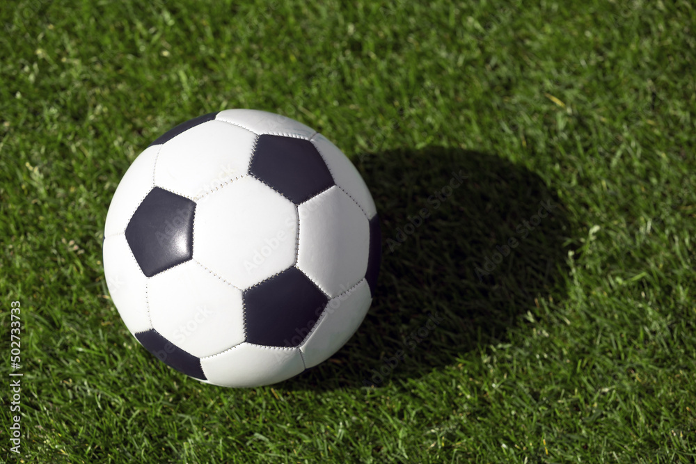 Classic soccer ball on grass field. View from above on retroc classic football ball. Sports soccer background Classic soccer ball on grass field. View from above on retroc classic football ball. Sports soccer background