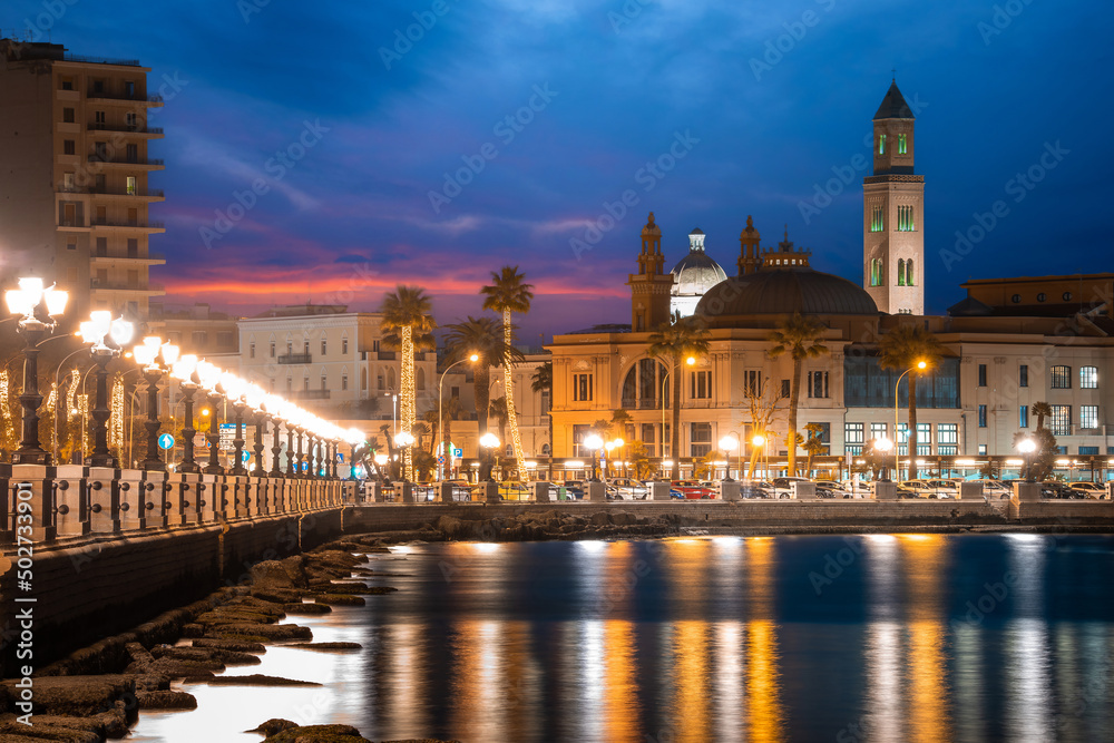 Fototapeta premium Panoramic view of Bari, Southern Italy, the region of Puglia(Apulia) seafront at dusk. Basilica San Nicola in the background. 