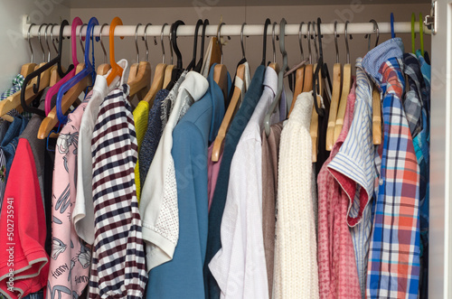 clothes in the closet on hangers