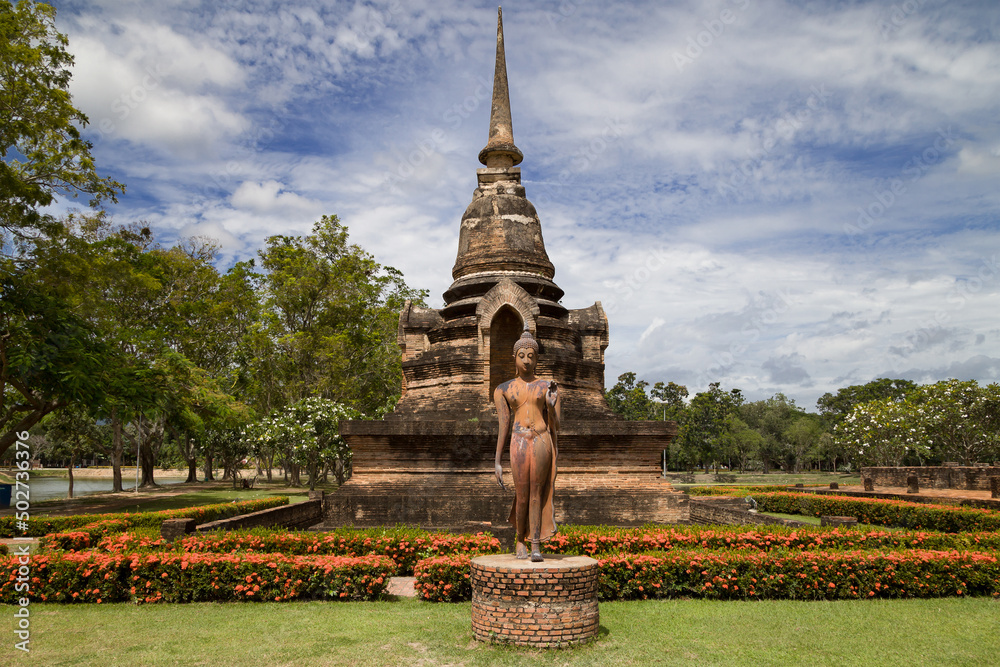 Walking Buddha and Minor Chedi at Wat Sa Si, Sukhothai, Thailand