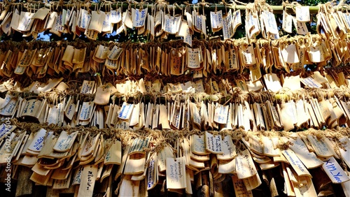 January-01-2022 : Ratchaburi, Thailand : selective focus on wooden hanging sign praying with Thai language at the temple in Suanphueng, Ratchaburi, Thailand.