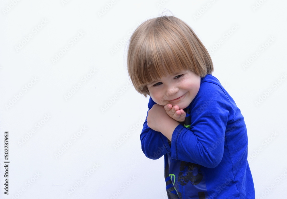 Cute sly boy smiles. Space for text. Tenderness and hugs Cute sly boy smiles. Space for text. Tenderness and hugs