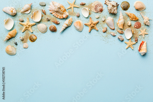 Summer time concept Flat lay composition with beautiful starfish and sea shells on colored table, top view with copy space for text