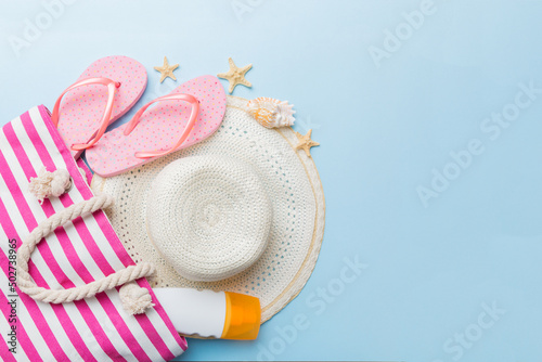 beach accessories flat lay top view on colored background Summer travel concept. Bag with starfish and sea shell. Top view