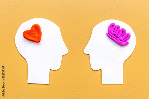 Brain and heart - logic and emotion. Communication between two paper human heads