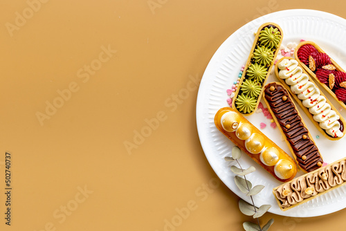 Set of french dessert eclairs with colorful topping