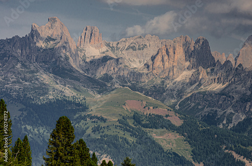 Panoramic view of the entire Catinaccio/Rosengarten mountain massif as seen from Buffaure mountain, above Fassa valley and Pozza di Fassa village, Dolomites, Trentino, Alto Adige, South Tyrol, Italy photo