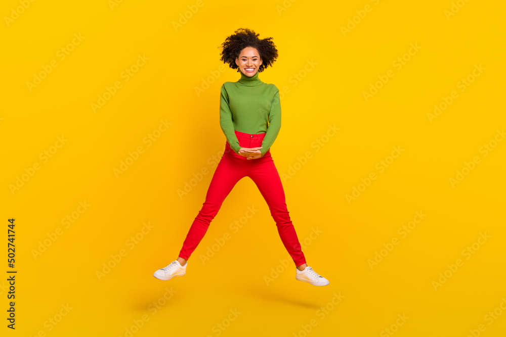 Full body photo of young cheerful girl good mood jump travel dream isolated over yellow color background
