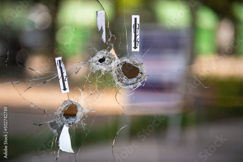 Foto Bullet holes on the window of local restaurant, shot during war shooting