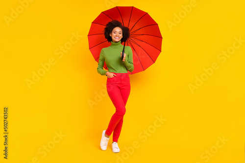 Full body photo of young cheerful lady hold parasol fall wear casual outfit isolated over yellow color background