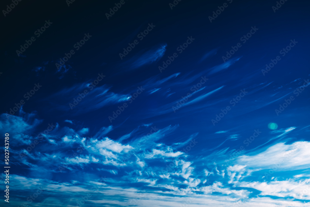 White spindrift clouds moving fast in dark blue sky. Cloudscape. Nature background. Windy weather forecast. Religion concept. Heaven landscape. Fresh air. Morning inspiration. Art. After storm. Peace White spindrift clouds moving fast in dark blue sky. Cloudscape. Nature background. Windy weather forecast. Religion concept. Heaven landscape. Fresh air. Morning inspiration. Art. After storm. Peace