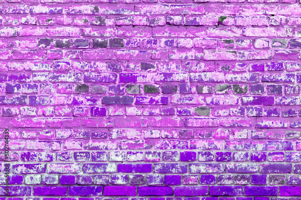Old pink brick wall. Peeling white paint on a pink wall.