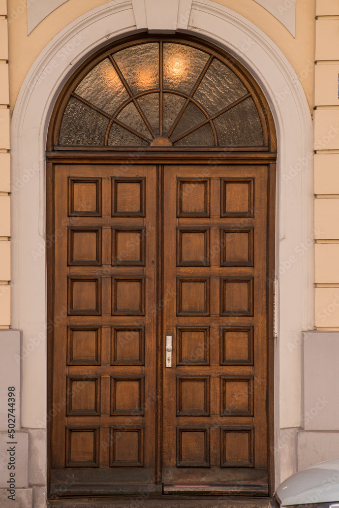 Munich, Germany - May 01, 2022: Old Decorative Main Entrance Wooden Door. Munich, Germany - May 01, 2022: Old Decorative Main Entrance Wooden Door.