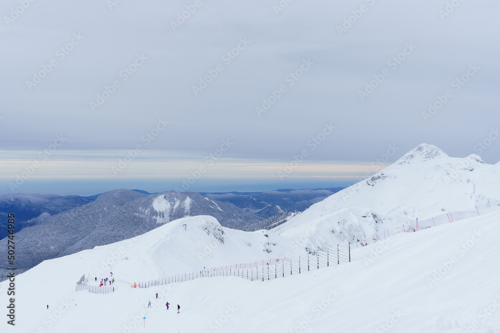 Winter mountain landscape: The Rosa Khutor Alpine Resort near Krasnaya Polyana panoramic background. Winter mountain landscape: The Rosa Khutor Alpine Resort near Krasnaya Polyana panoramic background.