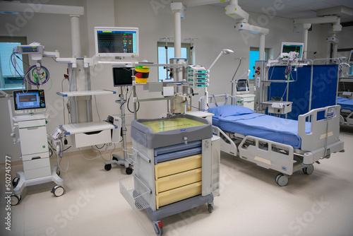 Empty Modern technology in intensive care unit room with different equipment and devices, beds and pillows.