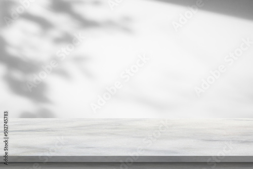 Marble table with tree shadow drop on white wall background for mockup product display