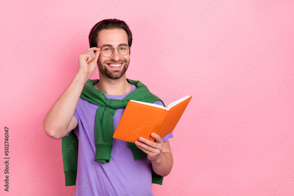 Photo of handsome good mood businessman reading professional book isolated on pink color background Photo of handsome good mood businessman reading professional book isolated on pink color background