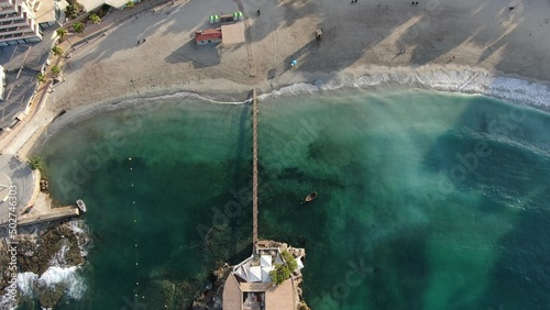 Beach holiday.Aerial cenital view of  a resort in the sea with a wood 
bridge from the beach to the restaurant. Concept of lifestyle, holiday, vacation, summer, relax and summer photo