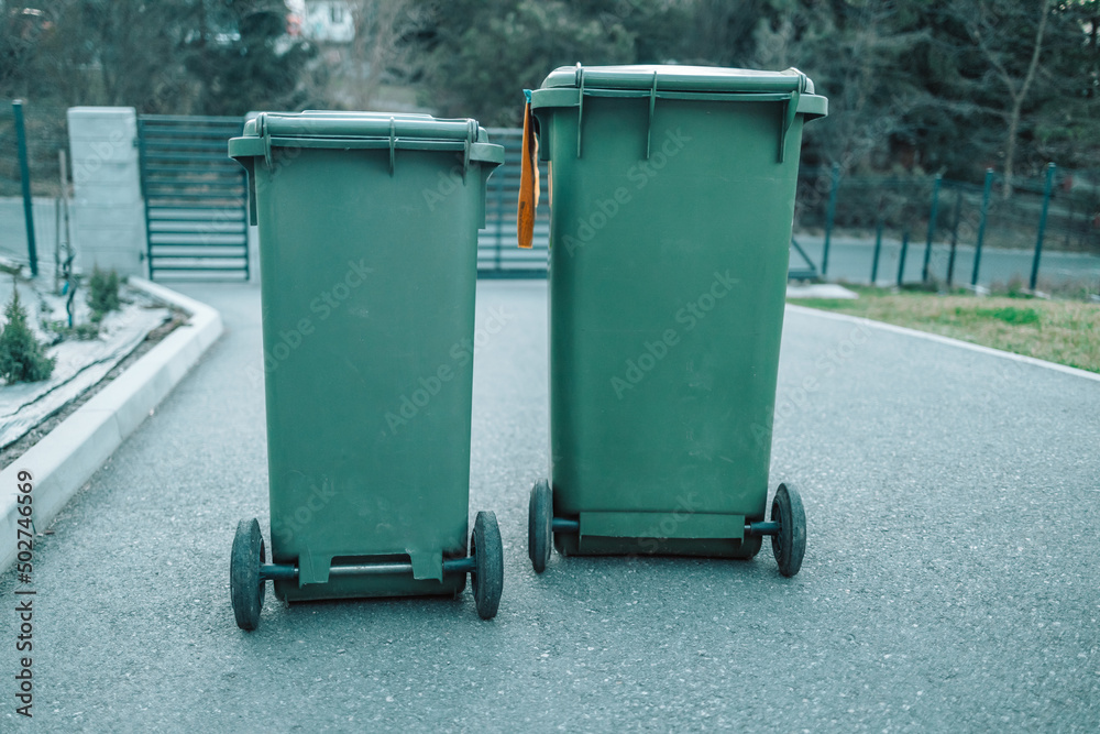 Green garbage cans are on the street. High quality photo Green garbage cans are on the street. High quality photo