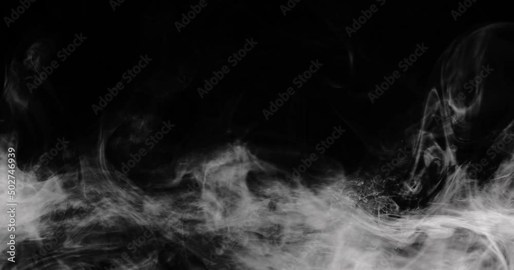Slow motion wispy cloud drifts around the lower third of the frame moving rightwards. Shot on black for easy composting.
