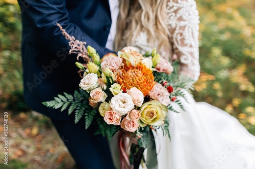 bride and groom holding bouquet