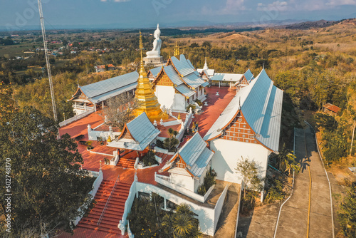 Wat Phrathat Pu Jae buddha and Huai Mae Toek lake in Phrae province, Thailand photo