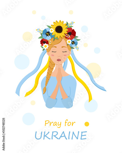 Beautiful ukrainian woman in a wreath with flowers prays for Ukraine. Stop war.