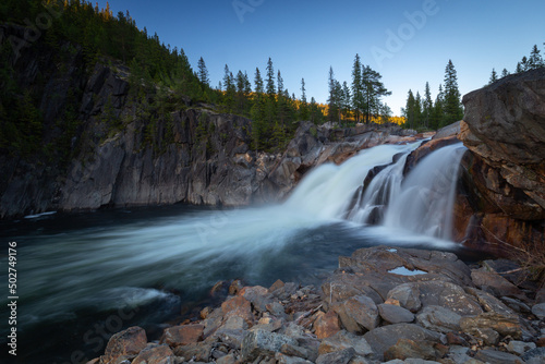 Flowing waterfall Hyttfossen with evening light. © Adrian