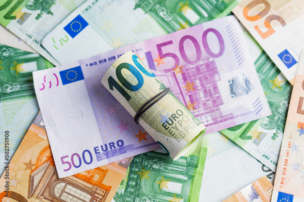 Euro in stationery band on pile of paper banknotes five one hundred and fifty euro. Heap of money Euro in stationery band on pile of paper banknotes five one hundred and fifty euro. Heap of money