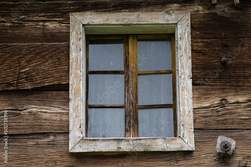 Croatia, May 01,2022 : Rustic style aged window at rural home wall.
