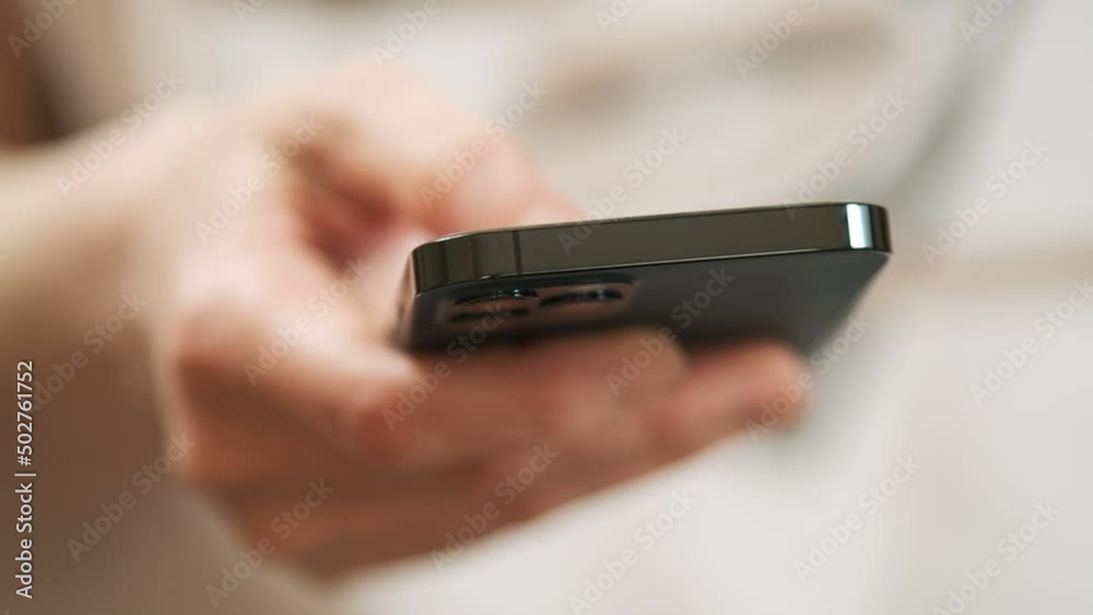 The hand is holding the screen, the mobile phone. Close up hand man using mobile smart phone. Hand holding smartphone device and touching screen The hand is holding the screen, the mobile phone. Close up hand man using mobile smart phone. Hand holding smartphone device and touching screen