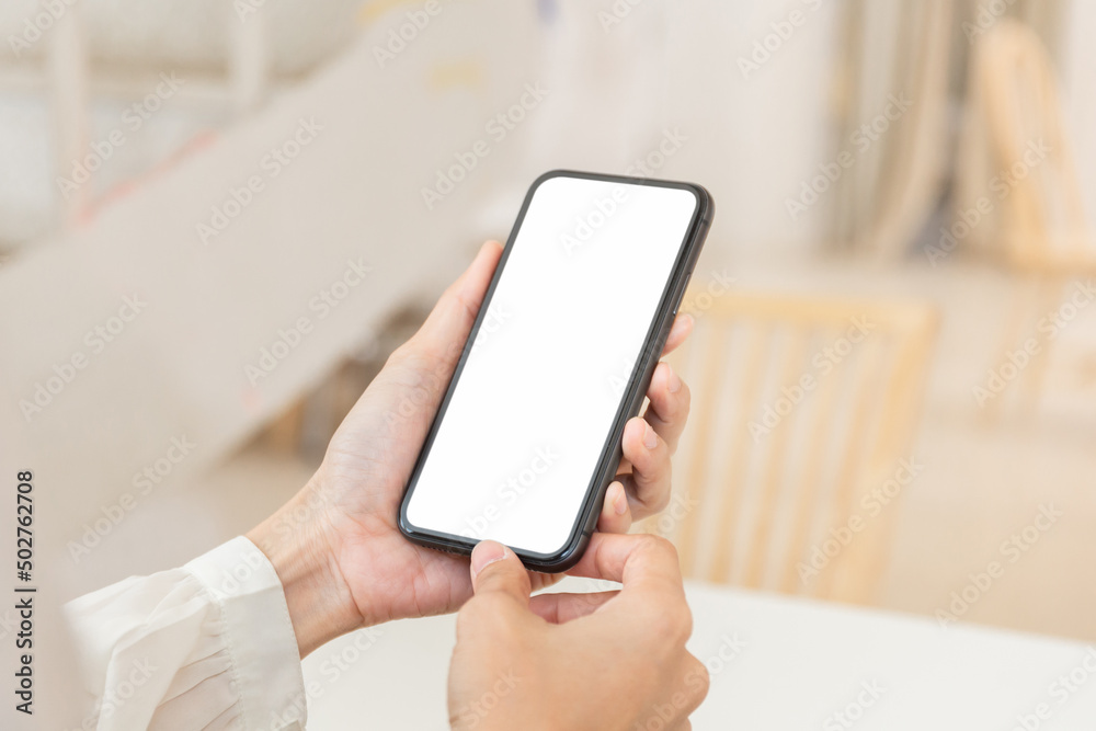 cell phone blank white screen mockup.hand holding texting using mobile on desk at office.background empty space for advertise.work people contact marketing business,technology cell phone blank white screen mockup.hand holding texting using mobile on desk at office.background empty space for advertise.work people contact marketing business,technology