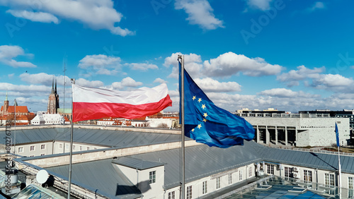 Waving polisg flag and european union flag on building photo