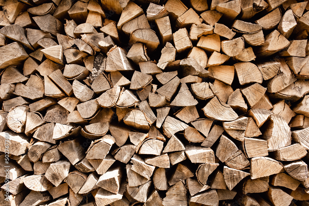 Background of stacked firewood. Chopped firewood. Background of stacked firewood. Chopped firewood.