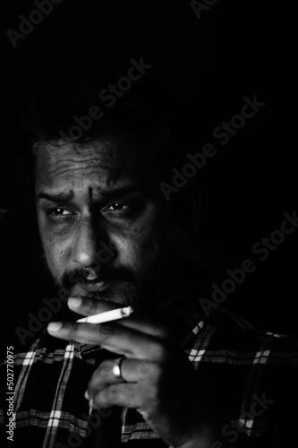 Handsome sexy man smoking cigarette in dark room , Santosh Kharat photo