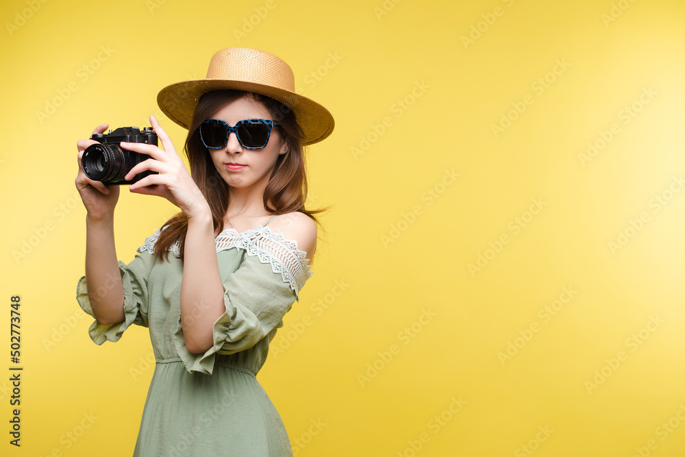 Young girl in straw hat and glasses keeping camera Young girl in straw hat and glasses keeping camera