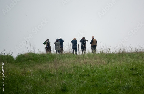 a group of bird watchers (twitchers) gather in search of a reported crane pair sighting on Salisbury Plain, Wiltshire