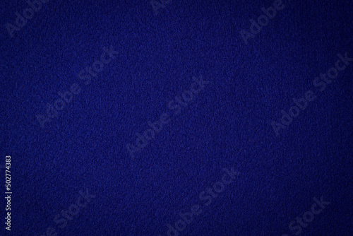 Navy blue color felt textile fabric material texture background. Abstract monochrome dark blue color felt background