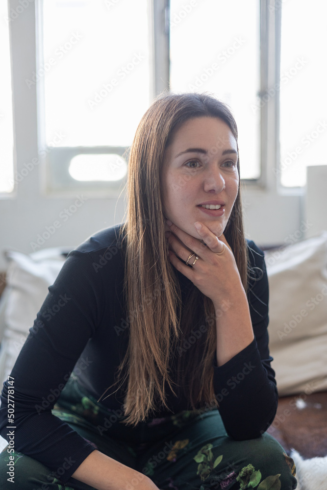 attractive caucasian woman sitting on couch, sofa in living room attractive caucasian woman sitting on couch, sofa in living room