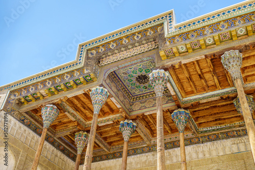 Close-up view of the carved wooden columns and painted ceilings of the street gallery (iwan) of the Bolo Haouz mosque, Bukhara, Uzbekistan